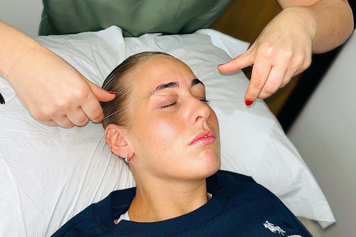 Girl getting her eyebrows threaded